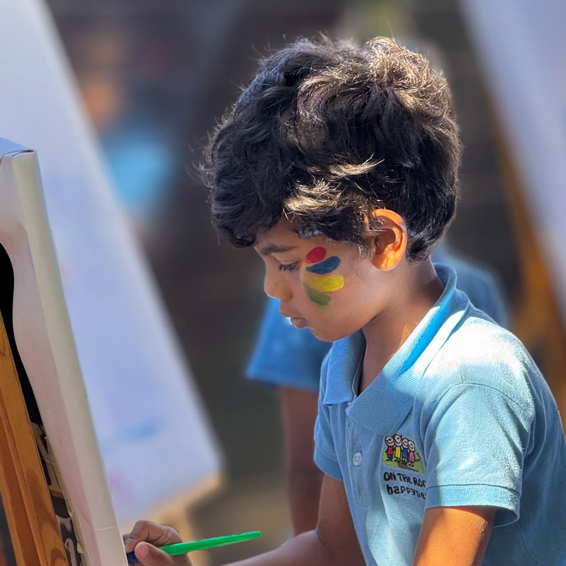 A child painting at an easel